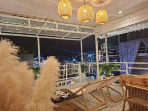 a balcony with a table and chairs and lights at U House Homeytel in Ban Tai