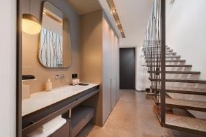 a bathroom with a sink and a staircase at Wine Lodge Pratenberg in Merano +152 photos