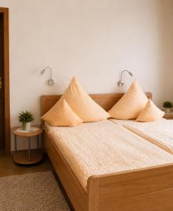 a bed with two pillows on it in a room at Gästehaus Stillecke in Erwitte