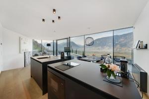 a large kitchen with a view of the mountains at Wine Lodge Pratenberg in Merano