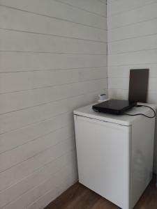 a laptop computer sitting on top of a white refrigerator at Owls' house B&B in Skriaudžiai