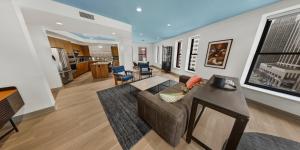 a living room with a couch and a table at Kimpton Schofield Hotel by IHG in Cleveland