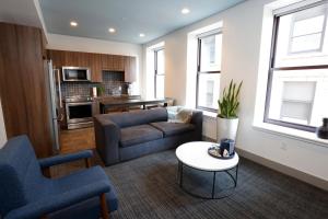 a living room with a couch and a table at Kimpton Schofield Hotel by IHG in Cleveland