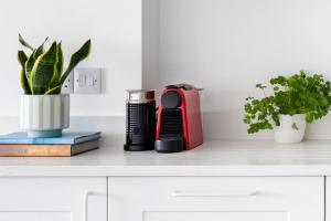 a desk with a red appliance and plants on it at Panoramic harbour views Morva in Falmouth