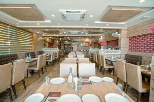 a dining room with tables and chairs in a restaurant at The Dwarika Hotel in Dwarka