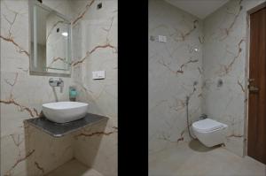 a bathroom with a sink and a toilet at Iskcon guest house in Patna +14 photos