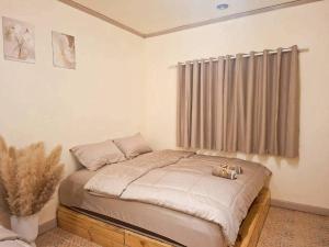 a small bed in a room with a window at U House Homeytel in Ban Tai +18 photos