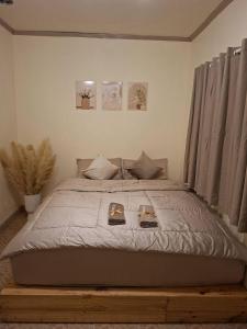 a bedroom with a large bed with two books on it at U House Homeytel in Ban Tai