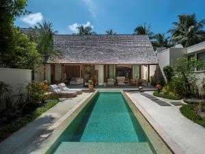a swimming pool in the backyard of a villa at Conrad Maldives Rangali Island in Mandhoo