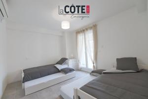 a living room with two beds and a couch at Duplex Villebois in Port-de-Bouc