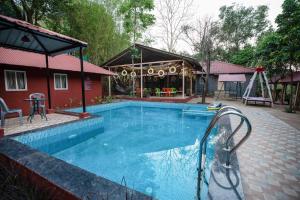 a swimming pool with a slide and a playground at Giri Mandala The Mountain Vihar in Welhe