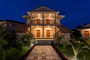 a villa with a staircase leading up to it at night at River Bank Jungle Resort, Chitwan in Chitwan