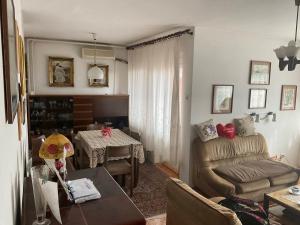 a living room with a couch and a table at City centar apartman in Zaječar