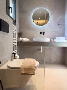 a bathroom with a sink and a toilet and a mirror at Elia Stay in Kalives Poligirou +63 photos