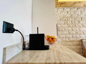 a counter top with a bowl of oranges and a lamp at Attique de la Moubra 4 in Crans-Montana