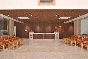 a large room with chairs and a podium in it at Iskcon guest house in Patna