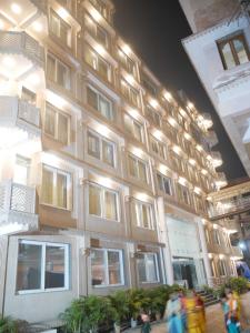 a building with people walking in front of it at Iskcon guest house in Patna