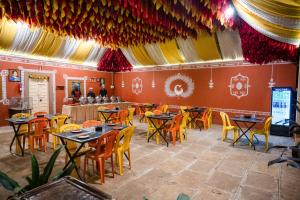 a restaurant with tables and chairs in a room at Giri Mandala The Mountain Vihar in Welhe