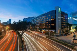 a city street at night with streaks of lights at Holiday Inn Singapore Orchard City Centre by IHG in Singapore