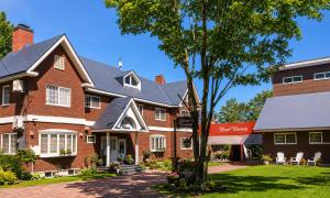 a large brick building with a tree in front of it at Heart Warmer in Myoko