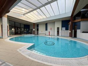 a large swimming pool in a large building at Craigmonie Hotel Inverness by Compass Hospitality in Inverness