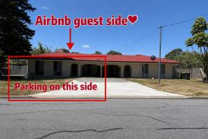 a house with a sign on the side of it at R1 Bright Spacious Room near Perth Airport in Perth +3 photos