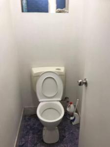 a bathroom with a white toilet in a room at R1 Bright Spacious Room near Perth Airport in Perth