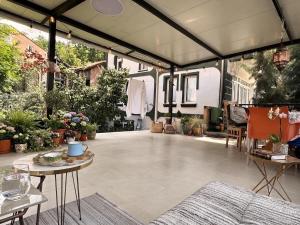 an outdoor patio with plants and a table and chairs at Private Guest Room with Garden Access in Skopje