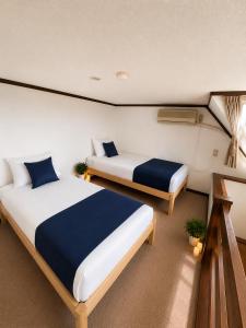 a bedroom with two beds in a room at Heart Warmer in Myoko