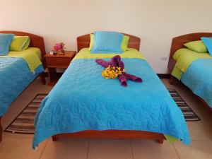 Een bed of bedden in een kamer bij Hostal Casa Cascada