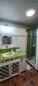 a bathroom with a sink and a shower at Belle Béarnaise in Bidos +15 photos