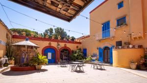 a courtyard with tables and chairs in a building at Agriturismo Duca di Castelmonte in Trapani