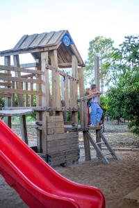 a young child on a slide in a playground at Agriturismo Duca di Castelmonte in Trapani +49 photos