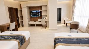 a hotel room with two beds and a dining room at Transit Hotel in Juba +24 photos