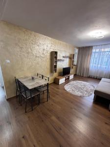 a living room with a table and a couch at Signature Studio Arad in Arad