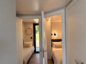 a bedroom with two beds and a mirror at Luxury Houseboat Wolphaartsdijk VP109 in Wolphaartsdijk