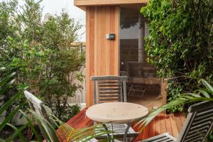 a patio with a table and chairs on a deck at Silvertree in Cape Town