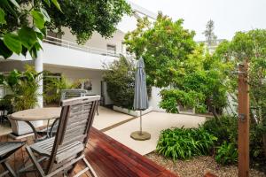 a patio with a table and an umbrella at Silvertree in Cape Town