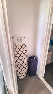 a bathroom with a toilet in the corner of a room at Lavish Lounge in Swansea