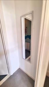 a mirror on a wall in a room at Lavish Lounge in Swansea