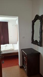 a small bedroom with a bed and a mirror at Hotel Sliv Elite Events in Blatec +2 photos