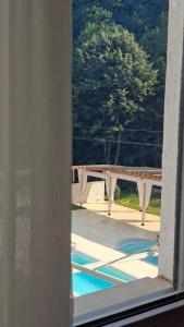 a view of a swimming pool through a window at Hotel Sliv Elite Events in Blatec