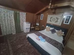 a bedroom with a large bed with pillows at Kashmir View group of Houseboat in Srinagar