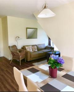 a living room with a couch and a table at Kiek-Ut-OG-mit-Studio-Nr-3 in Haby