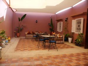 a room with a table and chairs and a couch at Riad Rabat Laalou in Rabat