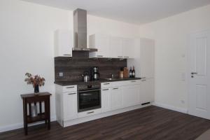 a kitchen with white cabinets and a stove at Kiek-Ut-OG-mit-Studio-Nr-3 in Haby +45 photos