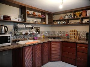 a kitchen with wooden cabinets and a counter top at Riad Rabat Laalou in Rabat