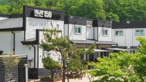 a row of houses with a sign on it at Hongcheon Pension 150 in Hongcheon