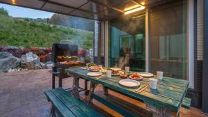 a table with plates of food and a grill at Hongcheon Pension 150 in Hongcheon