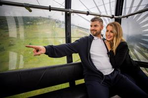 a man and a woman sitting on a roller coaster at Chalets Jasná Collection Centrum in Belá